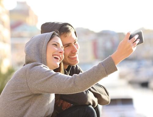 Man and woman taking a selfie together with hoodies on, indianapolis in