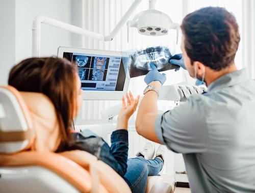Dentist showing a patient an xray, indianapolis in