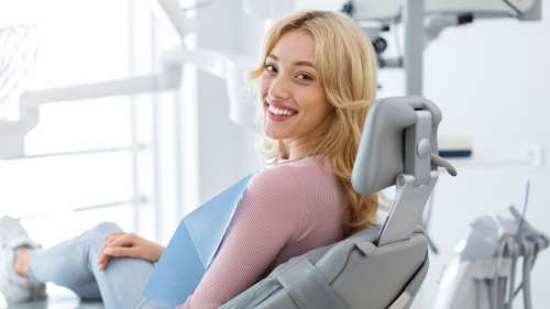 Blonde woman in chair smiling, indianapolis in