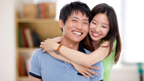 Asian man and woman smiling together, indianapolis in