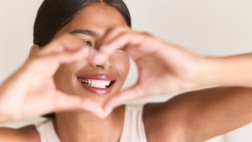 Woman holding hearts in front of her face, indianapolis in